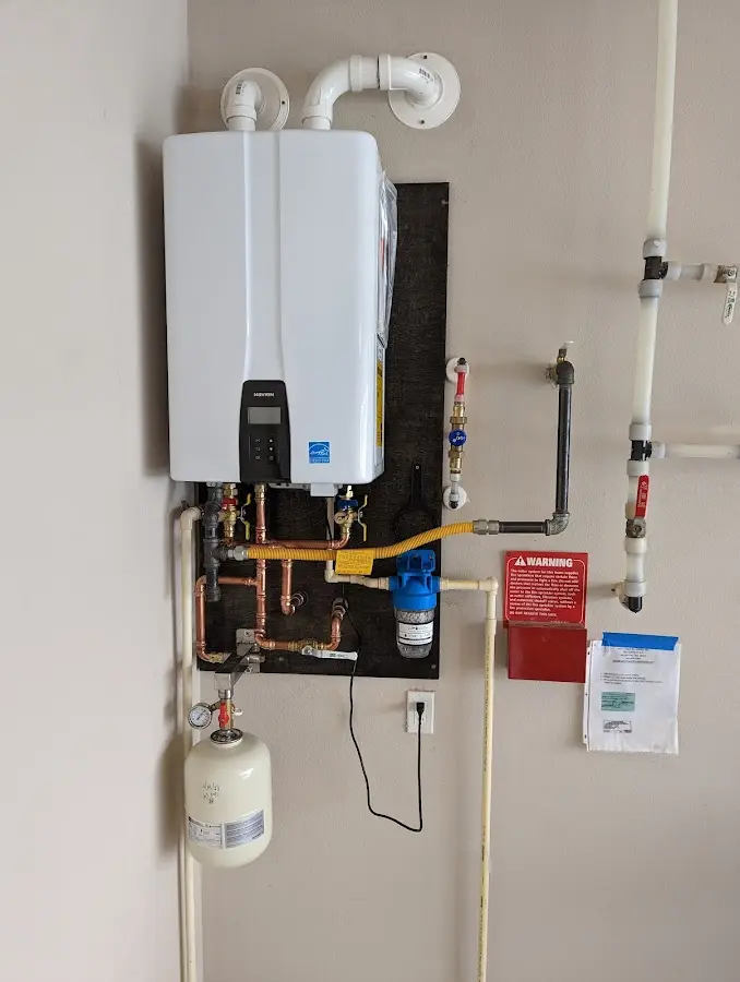 Professional plumber installing copper piping in a Fruit Hill home